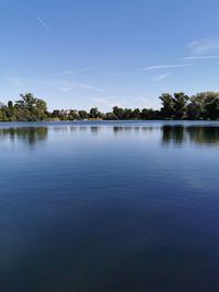 Scenic view of lake against blue sky