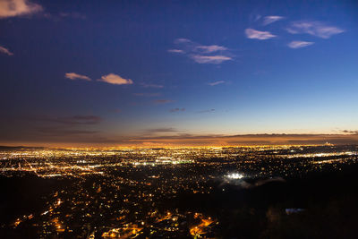 High angle view of illuminated buildings against sky at night