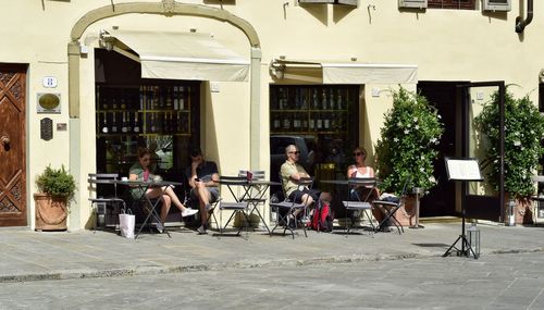 People sitting on bicycle in city