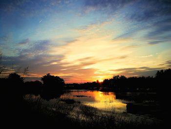 Scenic view of lake against sky during sunset