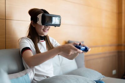 Girl playing games on virtual reality headset
