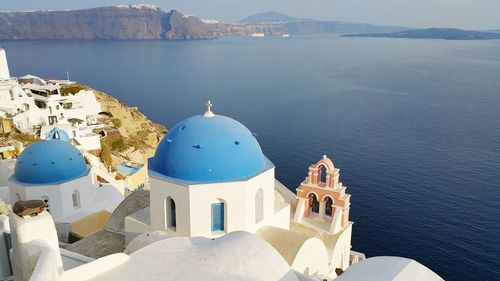 High angle view of white and blue church by sea