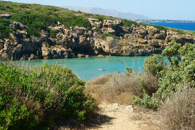 Scenic view of sea and mountains against sky