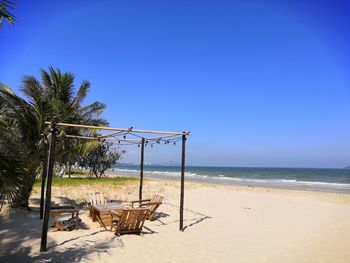 Scenic view of beach against clear blue sky