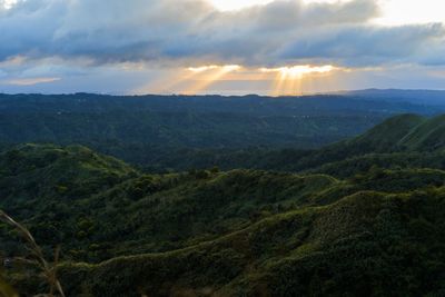 Scenic view of mountains against sky at sunset