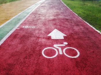 High angle view of arrow sign on road