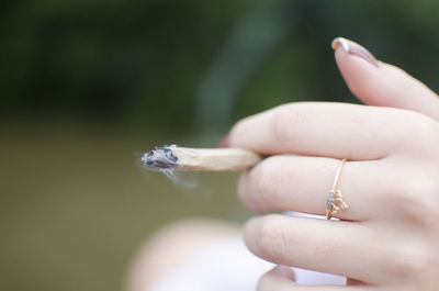 Close-up of woman hand holding a joint