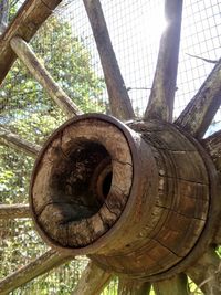 Close-up of rusty wheel by tree