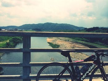 Scenic view of river against cloudy sky