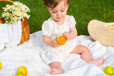 Cute baby girl lying on bed at home