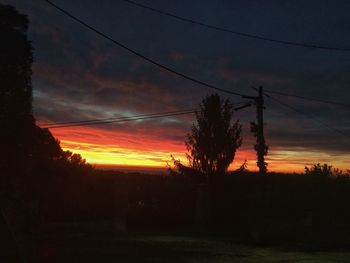 Silhouette trees against sky during sunset