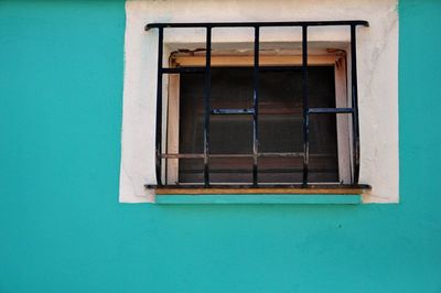 Low angle view of window on wall of building