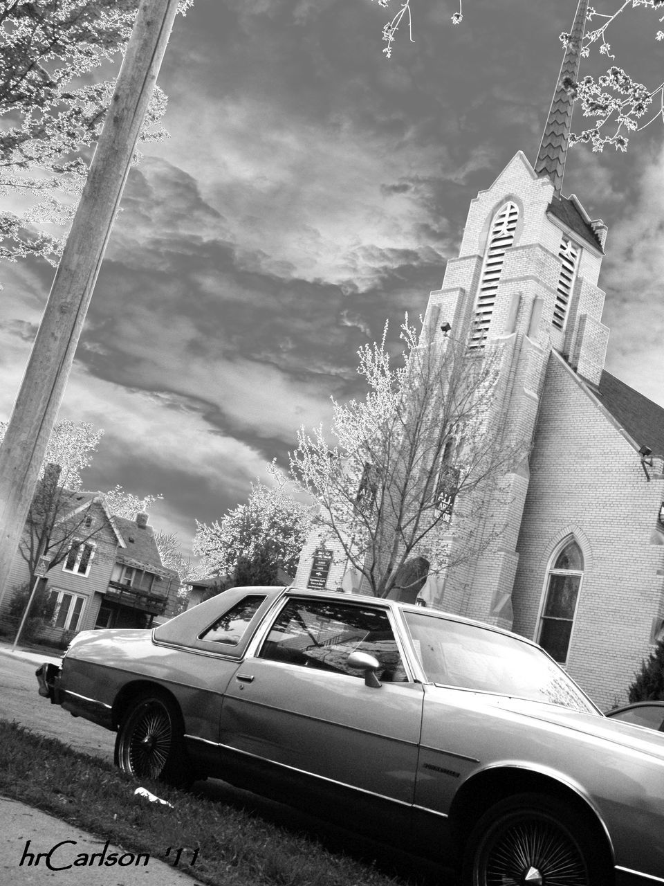 CARS ON ROAD AGAINST SKY IN CITY