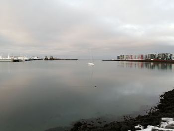 Sailboats in sea against sky