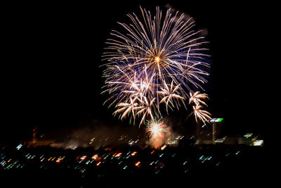 Low angle view of firework display at night