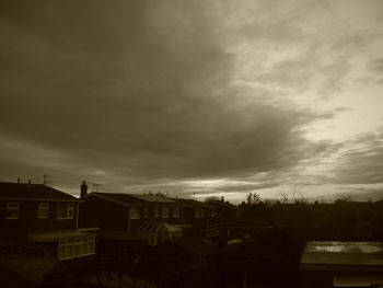 Buildings against cloudy sky