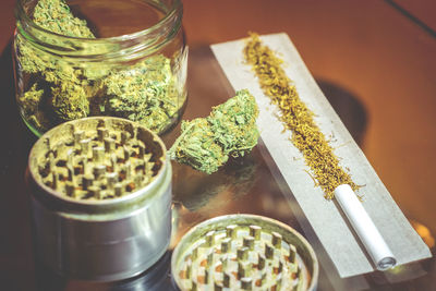 High angle view of cigarette in jar on table