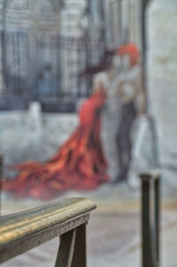 Close-up of railing against buildings in city