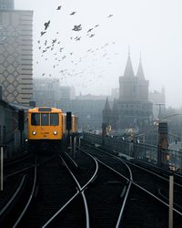 View of railroad tracks amidst buildings in city