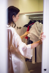 Side view of young woman using mobile phone