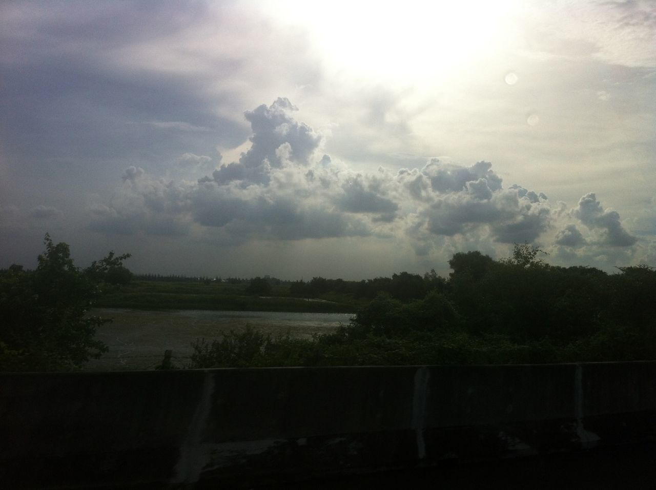 sky, tree, cloud - sky, tranquil scene, cloudy, beauty in nature, tranquility, scenics, nature, cloud, silhouette, landscape, growth, sunbeam, sunlight, weather, outdoors, idyllic, no people, water