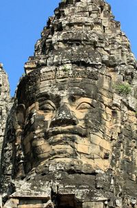 Low angle view of buddha statue against sky