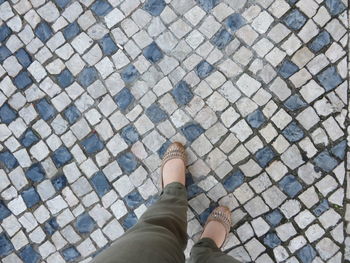 Low section of woman standing on street