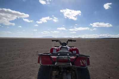 Horse cart on desert against sky