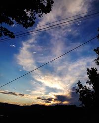 Low angle view of silhouette trees against sky at sunset