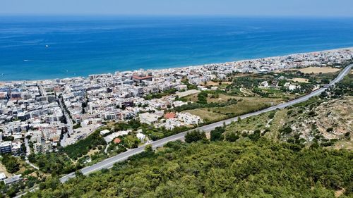 High angle view of buildings by sea against sky