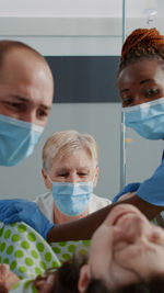 Portrait of young man wearing surgical mask