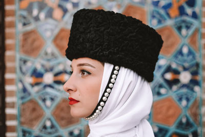 Portrait of young woman wearing hat