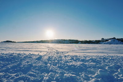 Scenic view of snow covered field against clear sky