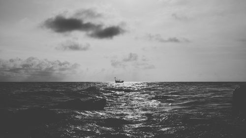 View of calm sea against cloudy sky