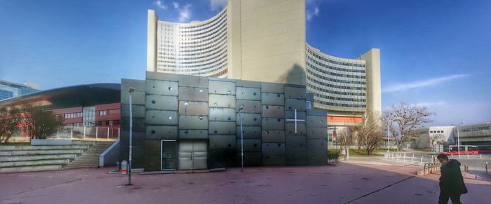 Buildings in city against blue sky