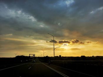 Street against sky during sunset