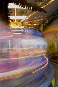 Light trails in amusement park at night