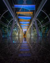 Man walking in illuminated tunnel
