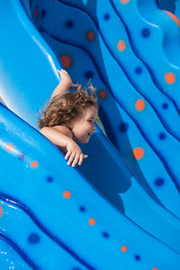Smiling girl on slide at water park