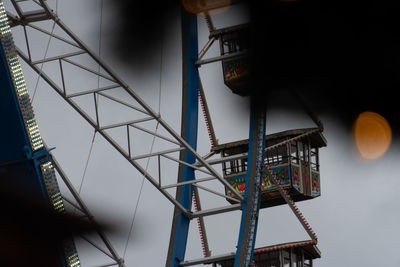 Low angle view of illuminated lighting equipment hanging in building