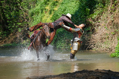 Person riding horse in a river