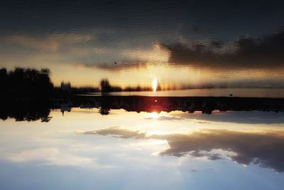 Scenic view of lake at sunset