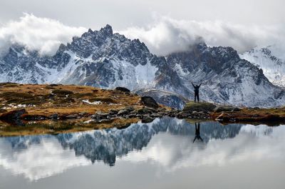 Scenic view of lake and snowcapped mountains against sky