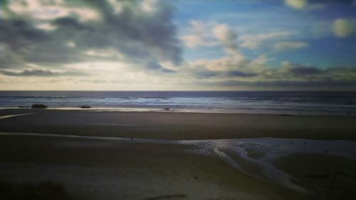 Scenic view of sea against cloudy sky