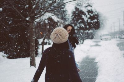 Rear view of woman in snow during winter