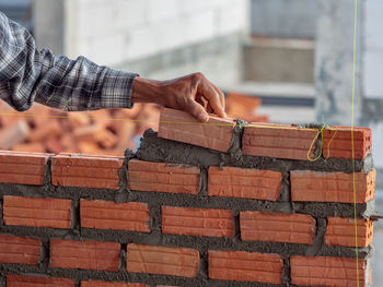 Midsection of man working on wood