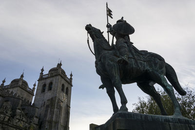 Low angle view of statue against sky