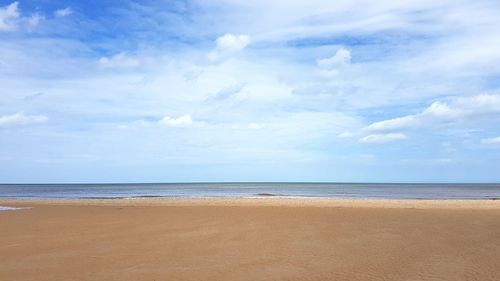 View of beach against cloudy sky