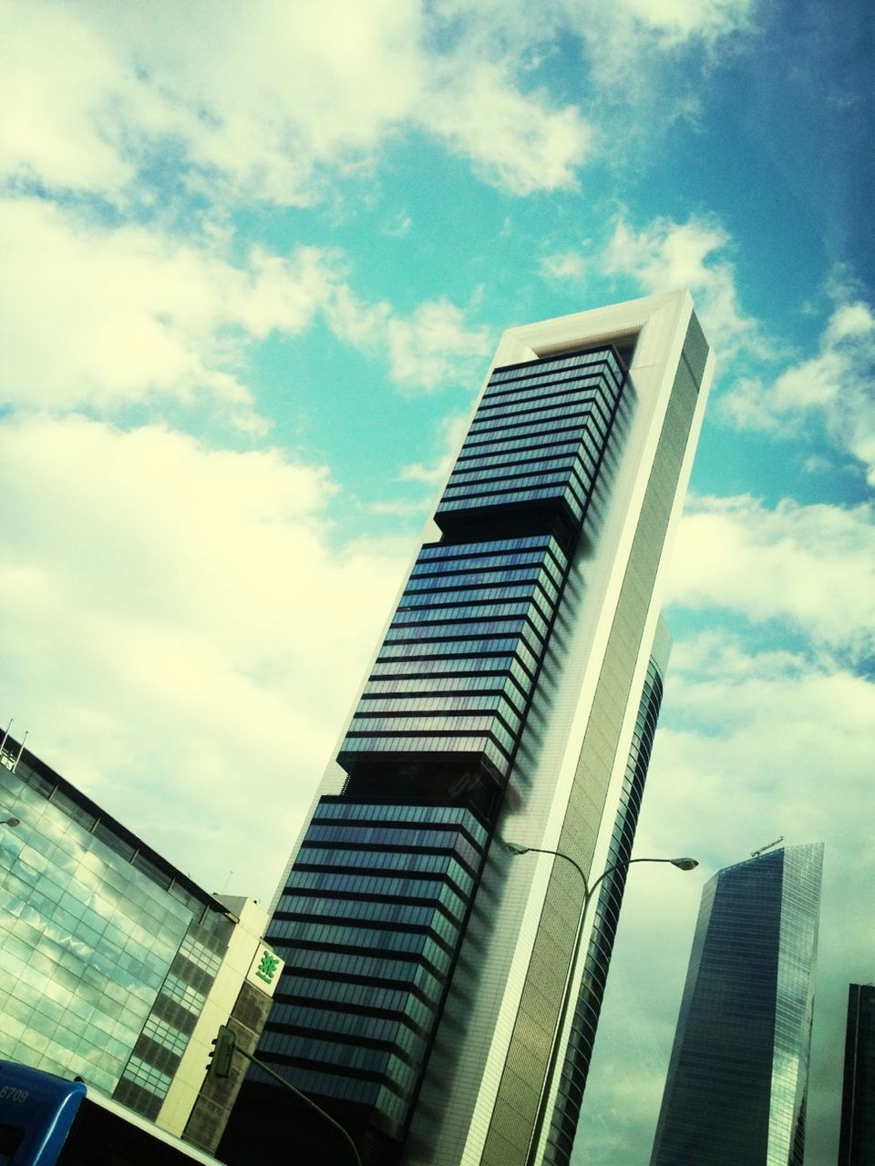 architecture, building exterior, built structure, low angle view, skyscraper, sky, city, modern, office building, tall - high, tower, building, cloud - sky, glass - material, window, cloud, tall, day, reflection, outdoors