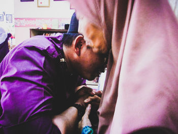 Portrait of man on purple indoors